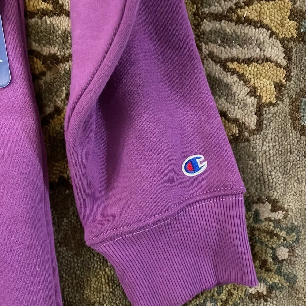 Children’s magenta long sleeved sweatshirt by Champion. Size large.NWT.